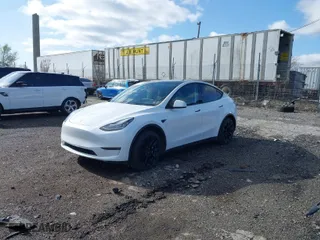 2023 Tesla Model Y Long Range with VIN 7SAYGDEE2PA059668, listed as a IAAI auction lot 41901079 with 58,276 mi miles. Bid and sale history available at carsss.com. Image 2.