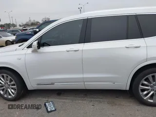 2021 Cadillac XT6 Premium Luxury z VIN 1GYKPCRSXMZ169206, wystawiony jako IAAI lot #41581841 z przebiegiem 64 789 mil mil oraz . Historia ofert i sprzedaży dostępna na DreamBid. Obrazek 14.