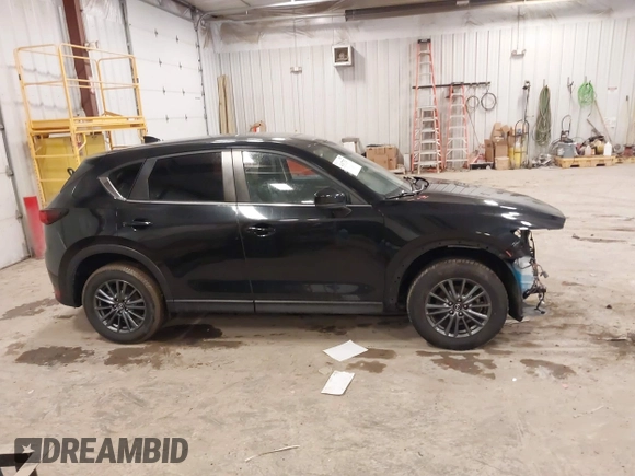 2021 Mazda CX-5 Touring with VIN JM3KFBCM1M1380409, listed as a IAAI auction lot 41677537 with 55,319 mi miles. Bid and sale history available at carsss.com. Image 13.