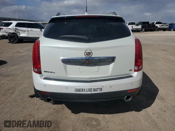2014 Cadillac SRX Premium Collection z VIN 3GYFNGE32ES573872, wystawiony jako Copart lot #49871955 z przebiegiem 119 362 mil mil oraz Szkody całkowita. Historia ofert i sprzedaży dostępna na DreamBid. Obrazek 6.