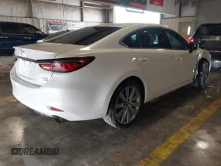 2021 Mazda 6 Carbon Edition with VIN JM1GL1WY9M1614117, listed as a IAAI auction lot 41305576 with 54,670 mi miles and . Bid and sale history available at DreamBid. Image 4.