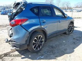 2016 Mazda CX-5 Grand Touring with VIN JM3KE2DY2G0715272, listed as a IAAI auction lot 41590492 with 134,176 mi miles. Bid and sale history available at carsss.com. Image 4.