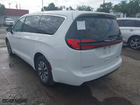2023 Chrysler Pacifica Hybrid Touring L with VIN 2C4RC1L74PR541551, listed as a IAAI auction lot 42028927 with 57,772 mi miles. Bid and sale history available at carsss.com. Image 3.