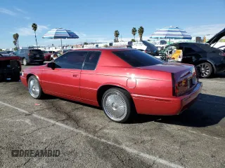 1999 Cadillac Eldorado Touring z VIN 1G6ET1293XU611368, wystawiony jako Copart lot #82683114 z przebiegiem 126 178 mil mil oraz Szkody całkowita. Historia ofert i sprzedaży dostępna na DreamBid. Obrazek 2.