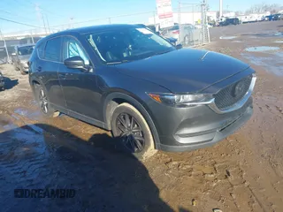 2018 Mazda CX-5 Touring z VIN JM3KFACM6J1417220, wystawiony jako IAAI lot #41123613 z przebiegiem 114 124 mil mil oraz . Historia ofert i sprzedaży dostępna na DreamBid. Obrazek 1.