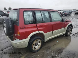 1998 Suzuki Sidekick z VIN JS3TD21VXW4103386, wystawiony jako Copart lot #86219924 z przebiegiem 172 959 mil mil oraz Szkody całkowita. Historia ofert i sprzedaży dostępna na DreamBid. Obrazek 3.