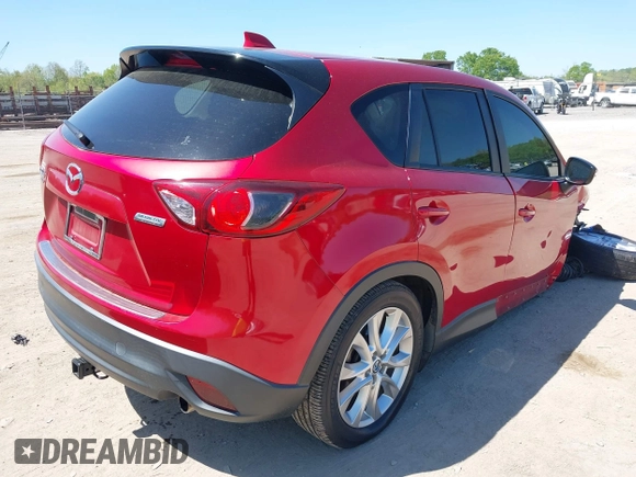 2015 Mazda CX-5 Grand Touring with VIN JM3KE4DY5F0469439, listed as a IAAI auction lot 42053851 with 70,676 mi miles. Bid and sale history available at carsss.com. Image 4.