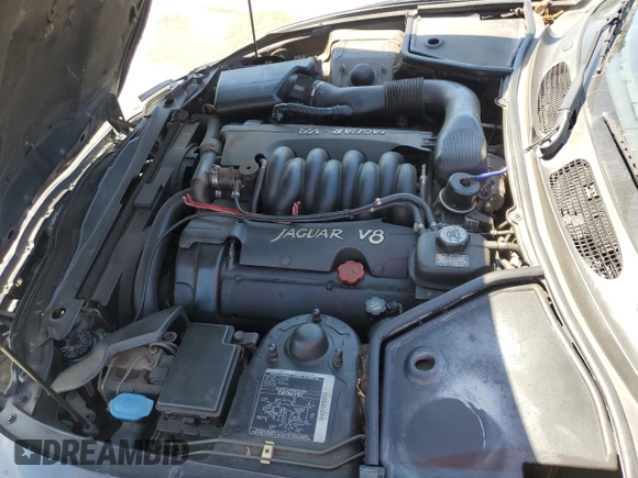 1997 Jaguar XK with VIN SAJGX5740VC014035, listed as a Copart auction lot 53066215 with 140,692 mi miles and Salvage Title. Bid and sale history available at DreamBid. Image 12.