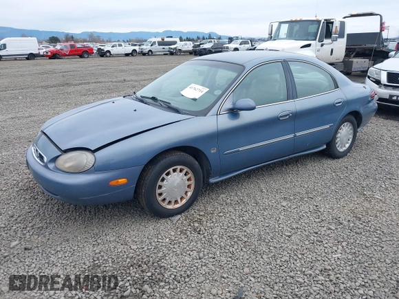 1999 Mercury Sable LS z VIN 1MEFM53S5XA647862, wystawiony jako IAAI lot #41762714 z przebiegiem 165 490 mil mil oraz . Historia ofert i sprzedaży dostępna na DreamBid. Obrazek 2.