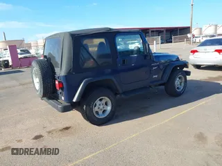 2002 Jeep Wrangler Sport z VIN 1J4FA49SX2P760671, wystawiony jako IAAI lot #41861841 z przebiegiem 125 728 mil mil oraz . Historia ofert i sprzedaży dostępna na DreamBid. Obrazek 4.