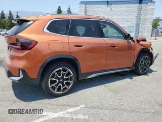 2023 BMW X1 xDrive28i with VIN WBX73EF03P5W54209, listed as a Copart auction lot 64796365 with 19,591 mi miles and Salvage title. Bid and sale history available at DreamBid. Image 3.