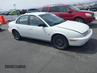 1998 Saturn SL z VIN 1G8ZJ5272WZ312413, wystawiony jako IAAI lot #41874493 z przebiegiem 229 200 mil mil oraz . Historia ofert i sprzedaży dostępna na DreamBid. Obrazek 13.