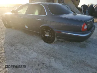 2004 Jaguar XJ with VIN SAJEA74C24SG09038, listed as a Copart auction lot 77015544 with Not Provided miles and Salvage Title. Bid and sale history available at DreamBid. Image 2.