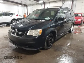 2014 Dodge Grand Caravan SXT with VIN 2C4RDGCGXER154709, listed as a IAAI auction lot 41117603 with 214,872 mi miles and . Bid and sale history available at DreamBid. Image 2.