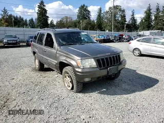 1999 Jeep Grand Cherokee Limited with VIN 1J4GW68S2XC677334, listed as a Copart auction lot 74152054 with 242,220 mi miles and Salvage Title. Bid and sale history available at carsss.com. Image 12.