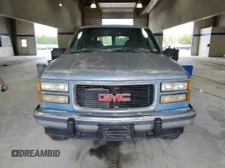 1994 GMC Suburban z VIN 1GKFK16K3RJ725171, wystawiony jako Copart lot #57914635 z przebiegiem 226 183 mil mil oraz Tytuł czysty. Historia ofert i sprzedaży dostępna na DreamBid. Obrazek 5.