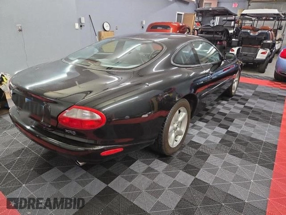 1997 Jaguar XK with VIN SAJGX5748VC006720, listed as a Copart auction lot 80928284 with 96,279 mi miles and Clean Title. Bid and sale history available at DreamBid. Image 4.