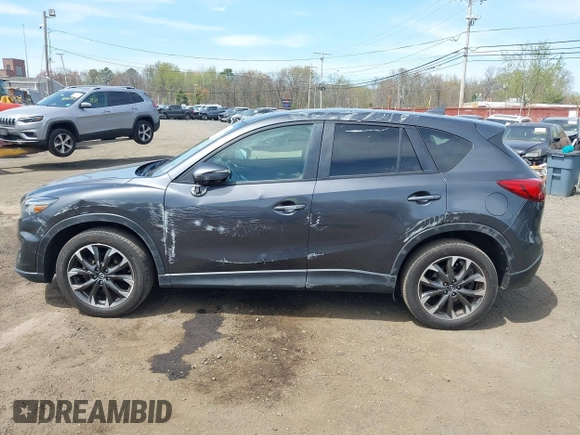 2016 Mazda CX-5 Grand Touring z VIN JM3KE4DY1G0893119, wystawiony jako IAAI lot #42049614 z przebiegiem 102 506 mil mil oraz . Historia ofert i sprzedaży dostępna na DreamBid. Obrazek 14.
