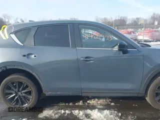 2021 Mazda CX-5 Touring z VIN JM3KFBCMXM0463469, wystawiony jako IAAI lot #41488993 z przebiegiem 28 582 mil mil oraz . Historia ofert i sprzedaży dostępna na DreamBid. Obrazek 13.