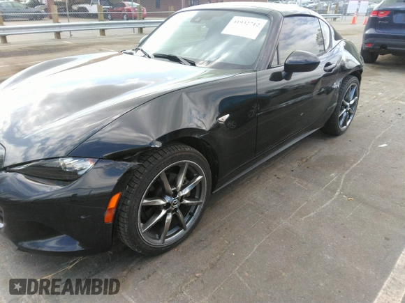 2021 Mazda MX-5 Miata Grand Touring z VIN JM1NDAM75M0451597, wystawiony jako IAAI lot #41932712 z przebiegiem 61 710 mil mil oraz . Historia ofert i sprzedaży dostępna na DreamBid. Obrazek 6.