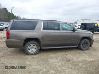 2015 Chevrolet Suburban LT z VIN 1GNSCJKC6FR675585, wystawiony jako IAAI lot #41510570 z przebiegiem 156 818 mil mil oraz . Historia ofert i sprzedaży dostępna na DreamBid. Obrazek 12.