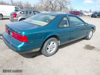 1997 Ford Thunderbird LX with VIN 1FALP62W7VH153454, listed as a IAAI auction lot 41833472 with 147,269 mi miles. Bid and sale history available at carsss.com. Image 4.