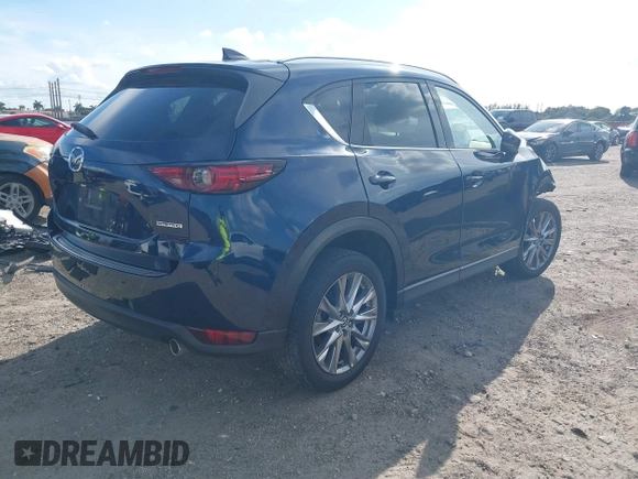 2021 Mazda CX-5 Grand Touring with VIN JM3KFADM0M0469886, listed as a IAAI auction lot 41617270 with 33,571 mi miles. Bid and sale history available at carsss.com. Image 4.