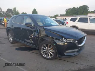2021 Mazda CX-5 Grand Touring with VIN JM3KFBDM7M0488246, listed as a IAAI auction lot 42056353 with 54,584 mi miles and . Bid and sale history available at DreamBid. Image 1.