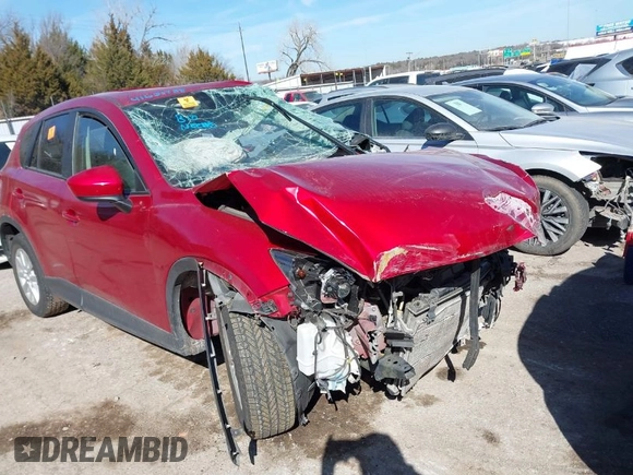 2014 Mazda CX-5 Touring z VIN JM3KE2CY2E0364488, wystawiony jako IAAI lot #41635188 z przebiegiem 127 688 mil mil oraz . Historia ofert i sprzedaży dostępna na DreamBid. Obrazek 1.