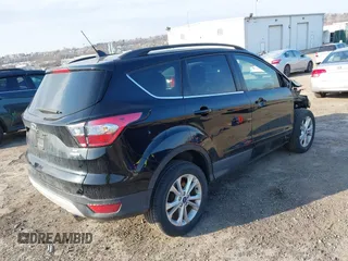 2018 Ford Escape SE z VIN 1FMCU9GD9JUC25456, wystawiony jako IAAI lot #41721436 z przebiegiem 55 642 mil mil oraz . Historia ofert i sprzedaży dostępna na DreamBid. Obrazek 4.