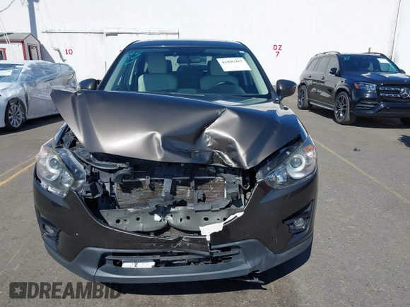 2016 Mazda CX-5 Grand Touring with VIN JM3KE2DYXG0773663, listed as a IAAI auction lot 41896367 with 86,571 mi miles and . Bid and sale history available at DreamBid. Image 13.