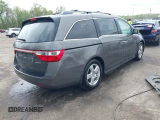2013 Honda Odyssey Touring with VIN 5FNRL5H94DB013310, listed as a IAAI auction lot 42079565 with 128,622 mi miles and . Bid and sale history available at carsss.com. Image 4.