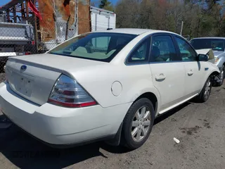 2009 Ford Taurus SE with VIN 1FAHP23W89G113022, listed as a IAAI auction lot 42118187 with 135,319 mi miles. Bid and sale history available at carsss.com. Image 4.