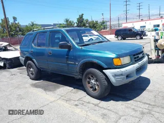 1998 Isuzu Rodeo S z VIN 4S2CK58W9W4313907, wystawiony jako IAAI lot #42843094 z przebiegiem 252 428 mil mil oraz . Historia ofert i sprzedaży dostępna na DreamBid. Obrazek 1.