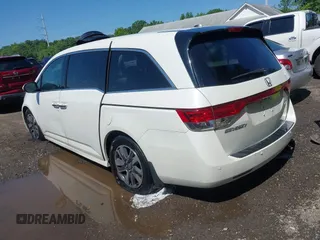2014 Honda Odyssey Touring with VIN 5FNRL5H94EB071788, listed as a IAAI auction lot 42523959 with 244,734 mi miles and . Bid and sale history available at DreamBid. Image 3.