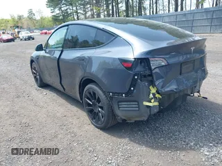 2020 Tesla Model Y Long Range with VIN 5YJYGDEE2LF029385, listed as a IAAI auction lot 42164786 with 58,685 mi miles and . Bid and sale history available at DreamBid. Image 3.