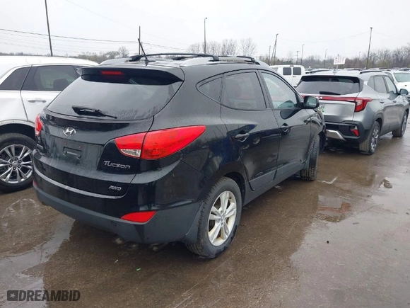 2011 Hyundai Tucson Limited with VIN KM8JUCAC5BU200544, listed as a IAAI auction lot 41952861 with 156,516 mi miles. Bid and sale history available at carsss.com. Image 4.