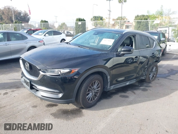 2021 Mazda CX-5 Touring with VIN JM3KFACM2M0339349, listed as a IAAI auction lot 41651005 with 53,792 mi miles. Bid and sale history available at carsss.com. Image 19.