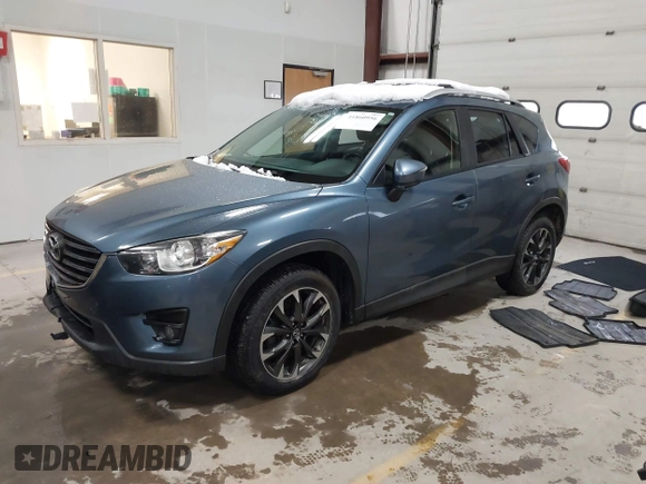 2016 Mazda CX-5 Grand Touring z VIN JM3KE4DY9G0714468, wystawiony jako IAAI lot #41860956 z przebiegiem 114 481 mil mil oraz . Historia ofert i sprzedaży dostępna na DreamBid. Obrazek 2.