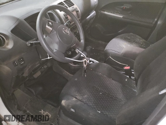 2014 Scion xD with VIN JTKKUPB48E1046627, listed as a Copart auction lot 61498995 with 63,452 mi miles and Salvage title. Bid and sale history available at DreamBid. Image 7.