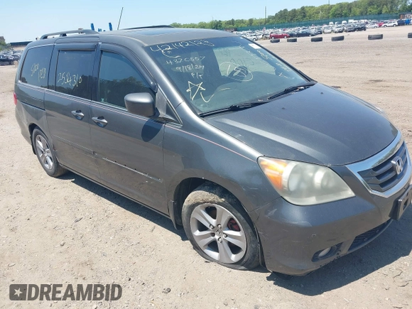 2010 Honda Odyssey Touring z VIN 5FNRL3H90AB085105, wystawiony jako IAAI lot #42142123 z przebiegiem Nie podano mil oraz . Historia ofert i sprzedaży dostępna na DreamBid. Obrazek 1.