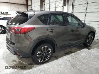 2016 Mazda CX-5 Grand Touring z VIN JM3KE2DY5G0821683, wystawiony jako Copart lot #51929905 z przebiegiem 119 392 mil mil oraz Czysty tytuł • Clean title. Historia ofert i sprzedaży dostępna na DreamBid. Obrazek 3.