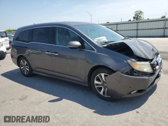 2014 Honda Odyssey Touring with VIN 5FNRL5H93EB061754, listed as a Copart auction lot 55182015 with 168,058 mi miles and Salvage title. Bid and sale history available at DreamBid. Image 4.