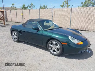 1999 Porsche Boxster z VIN WP0CA2986XU627495, wystawiony jako IAAI lot #42112724 z przebiegiem 94 090 mil mil oraz . Historia ofert i sprzedaży dostępna na DreamBid. Obrazek 1.