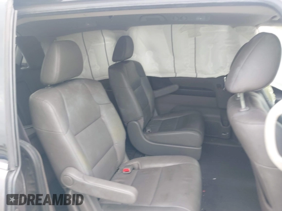 2016 Honda Odyssey Touring Elite with VIN 5FNRL5H97GB010048, listed as a IAAI auction lot 40212711 with 119,009 mi miles and . Bid and sale history available at DreamBid. Image 8.