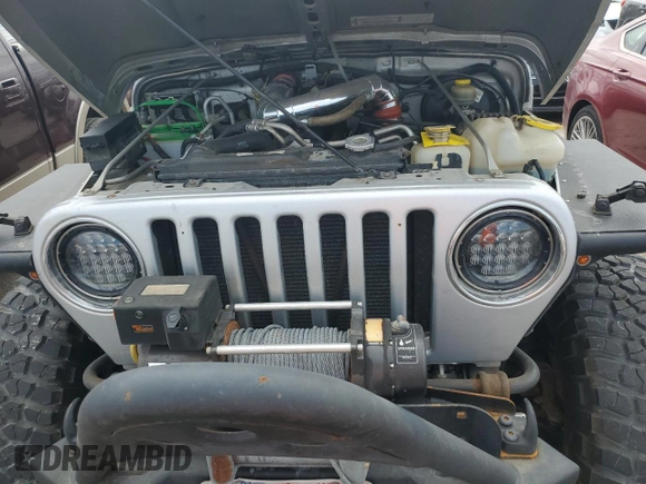 2003 Jeep Wrangler Rubicon z VIN 1J4FA69S53P340085, wystawiony jako Copart lot #74564574 z przebiegiem Nie podano mil oraz Szkoda całkowita • Salvage title. Historia ofert i sprzedaży dostępna na DreamBid. Obrazek 11.