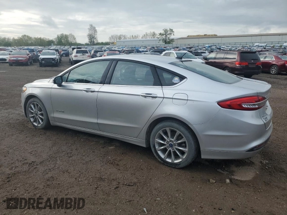 2017 Ford Fusion Hybrid SE z VIN 3FA6P0LU4HR384645, wystawiony jako Copart lot #56454995 z przebiegiem 165 322 mil mil oraz Czysty tytuł • Clean title. Historia ofert i sprzedaży dostępna na DreamBid. Obrazek 2.
