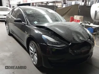 2019 Tesla Model 3 Mid Range with VIN 5YJ3E1EA1KF310863, listed as a IAAI auction lot 41380380 with 42,765 mi miles. Bid and sale history available at carsss.com. Image 1.