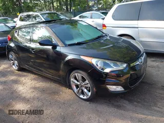 2013 Hyundai Veloster w/Red Int with VIN KMHTC6AD7DU165045, listed as a IAAI auction lot 42857142 with 49,964 mi miles and . Bid and sale history available at DreamBid. Image 1.