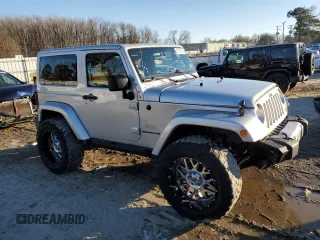 2011 Jeep Wrangler Sahara with VIN 1J4GA5D14BL628876, listed as a Copart auction lot 87317374 with 84,179 mi miles and Salvage Title. Bid and sale history available at DreamBid. Image 4.
